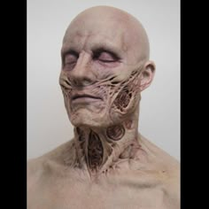 an alien man's head and neck is shown