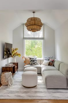 a living room filled with furniture and a large window