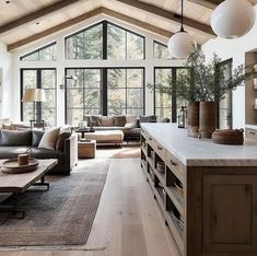 a living room filled with furniture and lots of windows