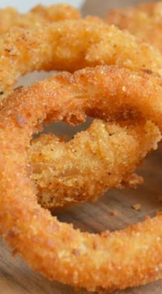 fried onion rings on a wooden cutting board