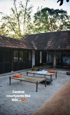 an outdoor area with benches and tables in front of a building that reads central courtyard like this