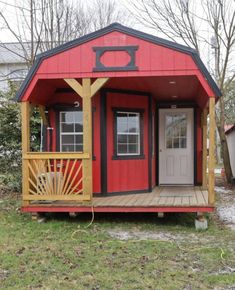 a small red and yellow house with a porch