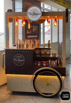 an ice cream cart with wheels and lights on the front is decorated in brown and white