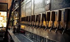 there are many beer taps lined up on the wall