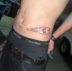 a man with a tattoo on his stomach has the number 35 tattooed on his side