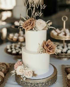 a white wedding cake with flowers on top