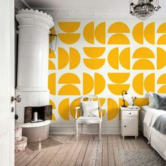 a bedroom decorated in yellow and white with a large wallpaper pattern on the wall