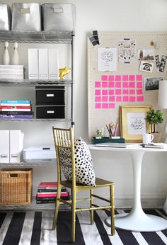 a white desk and chair in a room with black and white striped rugs on the floor