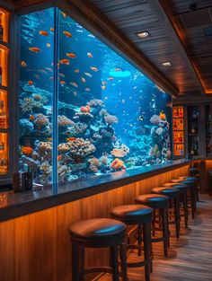 an aquarium is shown in the middle of a bar with stools at the end