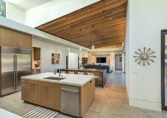 a kitchen with an island and stainless steel appliances