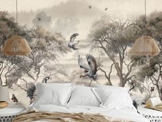 two birds flying in the air above a bed with white sheets and pillows on it