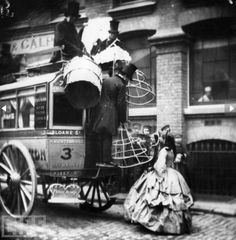 an old black and white photo of people on a horse drawn carriage