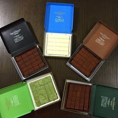 five different colored chocolates in boxes on a table