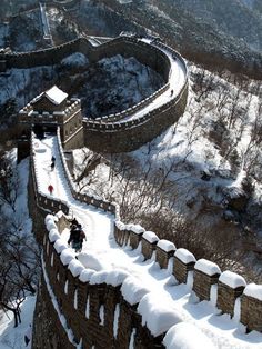 an aerial view of the great wall in winter