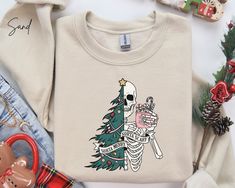 Christmas Sweatshirt, Christmas T Shirts all designed and printed at our store in Canada. DETAILS Gildan Softstyle 4.5 oz.(US) 7.5 oz.(CA), 100% preshrunk ring spun cotton Semi-fitted High stitch density for smoother printing surface Seamless double needle 3/4" collar Taped neck and shoulders Rolled forward shoulder Double needle sleeve and bottom hems Quarter-turned to eliminate center crease Tear away label Fabric Profile : Antique colours & Sport Grey: 90/10 cotton/polyester Heather colours & Skeleton Christmas Sweater, Horror Christmas Sweater, Meowy Christmas Shirt, Spooky Cat Print Crew Neck T-shirt, Spooky Cotton T-shirt With Cat Print, Christmas Tree Shirt, Funny Christmas Sweaters, Funny Christmas Gifts, Tree Shirt