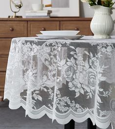 the table cloth is white and has flowers on it