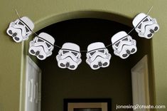 star wars decorations are hanging on the wall above a doorway in a room with green walls