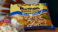 a bag of ramen noodles is sitting on a table next to some other food