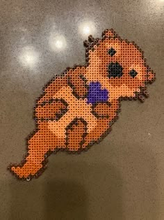 an image of a dog that is made out of perforated paper and beads