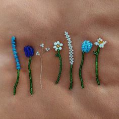 four beaded flowers are arranged on the side of a woman's stomach,