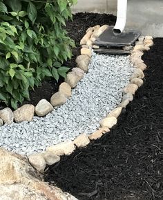 a garden with rocks and gravel around it