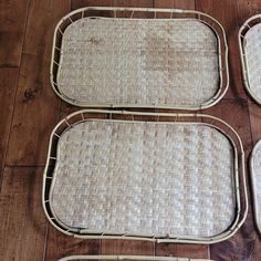 three wicker trays sitting on top of a wooden floor