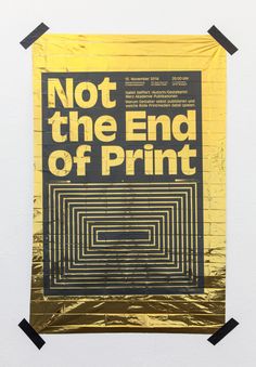 a poster that says not the end of print on a piece of gold foil with black tape around it