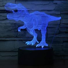 a blue 3d dinosaur lamp on a table