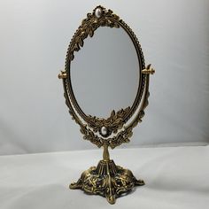 an ornate gold mirror on a white background