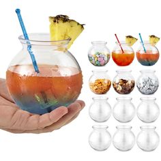 a hand holding a glass filled with liquid and some candy in it, next to several different types of drinks