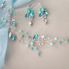 Turquoise hair clip for bride Teal blue hair comb Bridal hair piece This turquoise  wedding hair piece is made of: - crystal beads - turquoise beads - rhinestones - jewelry wire On the picture of the product you see a product using : clear and tourquoise (teal) crystal beads, clear and  turquoise crystal  rhinestones and silver jewelry wire. The length of the decoration on the photo is 6 1/2 inches. Additional Information -Product will be placed into a gift box -If you need a different color of wire, you can choose it in the list -this is handmade item If you need jewelry or accessories in the color of your wedding, please let me know about it. I will certainly make it the way you need it. All our buyers receive a track number to control location of the parcel at any time. The delivery tim Teal Blue Hair, Turquoise Wedding Jewelry, Hair Vine Bridal, Turquoise Hair, Bridal Hair Piece, Turquoise Wedding, Turquoise Crystal, Bridal Hair Vine, Jewelry Wire