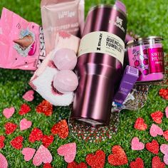 valentine's day gift basket on the grass with pink and red heart shaped confetti