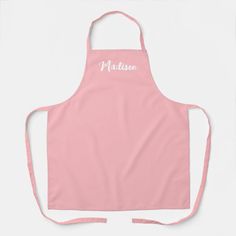 a pink apron with the word madison in white on it and an embroidered name across the front