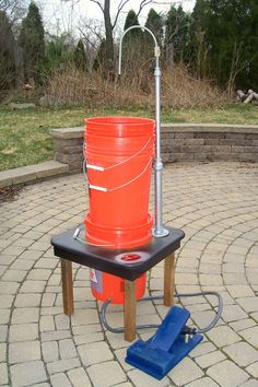 an orange bucket sitting on top of a table