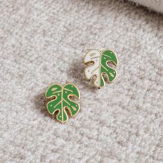 Monstera Albo earrings capture the plant's coveted variegation in a playful mismatched pair--one leaf lush green, the other half white. Perfect for showing off your unique style, just like each unique leaf of the Monstera Albo itself! Enamel earring with polished gold-plated metal, featuring stainless steel posts with 0.5" (13 mm) extra-long design for secure, stable wear, paired with silicone cone backs for a snug fit. Features 10x6mm full-cover, dust-proof studs. Details: * One pair of stud ea Monstera Albo, Plant Earrings, Nickel Allergy, The Other Half, Other Half, Enamel Earrings, Style Expert, Lush Green, Buttons Pinback