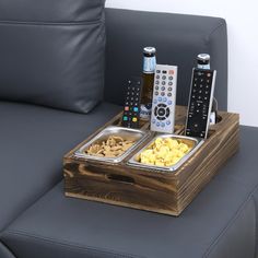 two trays filled with food and remote controls