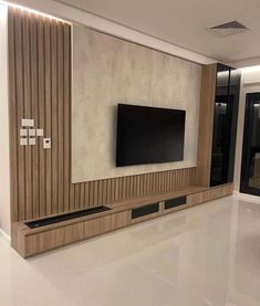 an empty room with a flat screen tv on the wall