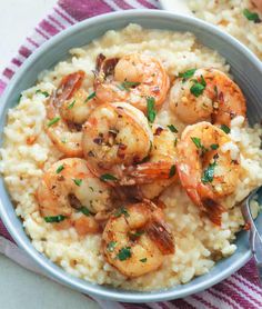 two bowls filled with rice and shrimp on top of each other