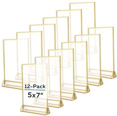 six gold metal frames with clear glass shelves on each side and the number one in front