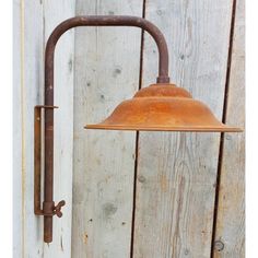 an old - fashioned light fixture is hanging on a wooden wall next to a door