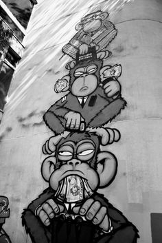 a mural on the side of a building depicts monkeys