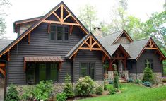 a large house with lots of windows and wood trimmings on the side of it