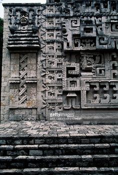 an intricately carved stone wall in the ruins of chichenangon, mexico