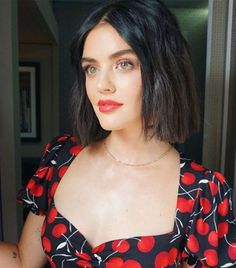 a woman in a red and black dress is taking a selfie