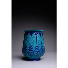 a blue vase sitting on top of a table