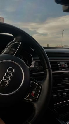 the steering wheel and dashboard of an audi car