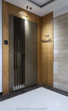 an elevator with wooden walls and metal doors