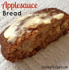 a close up of a piece of bread with icing on it and the words applesauce bread