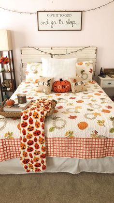 a bed with pumpkins and other decorations on it