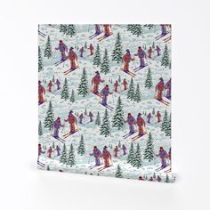 a christmas wrapping paper with skiers and trees in the snow on it, against a white background